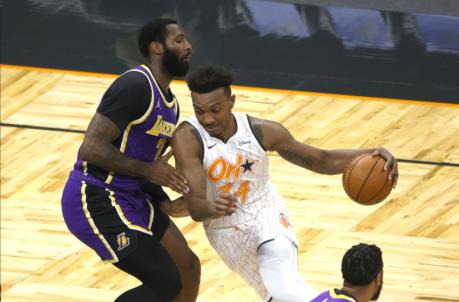 Apr 26, 2021; Orlando, Florida, USA; Orlando Magic center Wendell Carter Jr. (34) drives to the basket as Los Angeles Lakers center Andre Drummond (2) defends during the first quarter at Amway Center. Mandatory Credit: Kim Klement-USA TODAY Sports