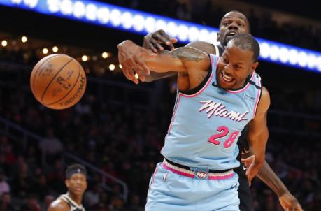 Andre Iguodala #28 of the Miami Heat denies a shot by Dewayne Dedmon #14 (Photo by Todd Kirkland/Getty Images)