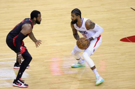 HOUSTON, TEXAS - APRIL 23: Paul George #13 of the Los Angeles Clippers dribbles against John Wall #1 of the Houston Rockets during the first quarter at Toyota Center on April 23, 2021 in Houston, Texas. NOTE TO USER: User expressly acknowledges and agrees that, by downloading and or using this photograph, User is co<em></em>nsenting to the terms and co<em></em>nditions of the Getty Images License Agreement (Photo by Carmen Mandato/Getty Images )