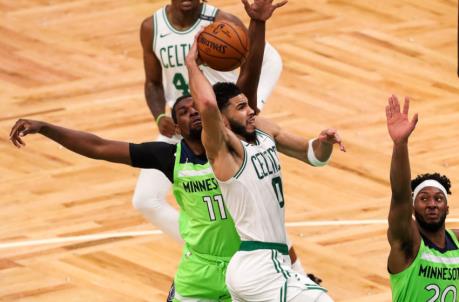 Apr 9, 2021; Boston, Massachusetts, USA; Boston Celtics forward Jayson Tatum (0) shoots during the second half defended by Minnesota Timberwolves center Naz Reid (11) at TD Garden. Mandatory Credit: Paul Rutherford-USA TODAY Sports