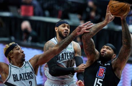 Apr 20, 2021; Portland, Oregon, USA; LA Clippers center DeMarcus Cousins (15) shoots over Portland Trail Blazers forward Ro<em></em>ndae Hollis-Jefferson (2) and forward Carmelo Anthony (00) during the second quarter at the Moda Center. Mandatory Credit: Craig Mitchelldyer-USA TODAY Sports