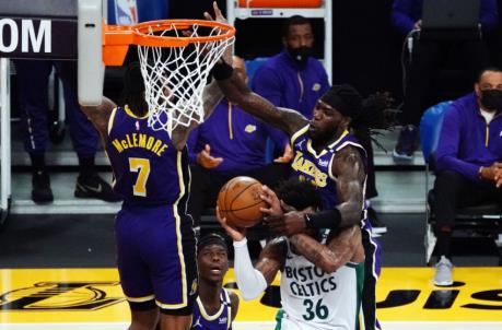 Apr 15, 2021; Los Angeles, California, USA; Boston Celtics guard Marcus Smart (36) loses the ball against the defense of Los Angeles Lakers center Mo<em></em>ntrezl Harrell (15) during the first half at Staples Center. Mandatory Credit: Gary A. Vasquez-USA TODAY Sports