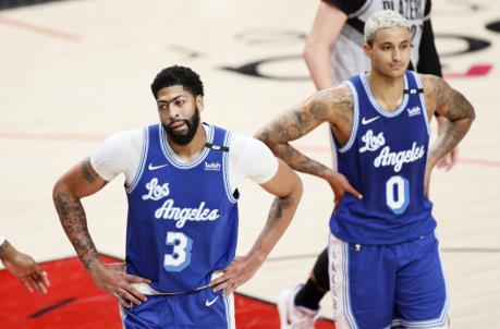 PORTLAND, OREGON - MAY 07: Anthony Davis #3 and Kyle Kuzma #0 of the Los Angeles Lakers react during the third quarter against the Portland Trail Blazers at Moda Center on May 07, 2021 in Portland, Oregon. NOTE TO USER: User expressly acknowledges and agrees that, by downloading and or using this photograph, User is co<em></em>nsenting to the terms and co<em></em>nditions of the Getty Images License Agreement. (Photo by Steph Chambers/Getty Images)