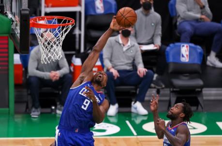 Mar 2, 2021; Boston, Massachusetts, USA; Los Angeles Clippers center Serge Ibaka (9) rebounds the ball during the second half against the Boston Celtics at TD Garden. Mandatory Credit: Paul Rutherford-USA TODAY Sports