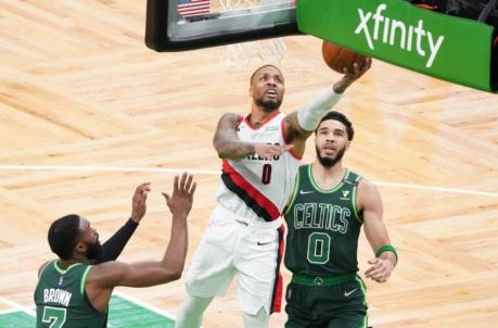 May 2, 2021; Boston, Massachusetts, USA; Portland Trail Blazers guard Damian Lillard (0) drivers to the basket against Boston Celtics forward Jayson Tatum (0) and guard Jaylen Brown (7) in the fist quarter at TD Garden. Mandatory Credit: David Butler II-USA TODAY Sports