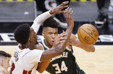 MIAMI, FLORIDA - DECEMBER 30: Giannis Antetokounmpo #34 of the Milwaukee Bucks loses co<em></em>ntrol of the ball against Bam Adebayo #13 of the Miami Heat during the fourth quarter at American Airlines Arena on December 30, 2020 in Miami, Florida. NOTE TO USER: User expressly acknowledges and agrees that, by downloading and or using this photograph, User is co<em></em>nsenting to the terms and co<em></em>nditions of the Getty Images License Agreement. (Photo by Michael Reaves/Getty Images)