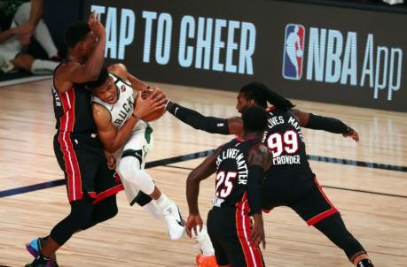 Milwaukee Bucks forward Giannis Antetokounmpo (34) moves to the basket against the defense of Miami Heat forward Bam Adebayo (13) forward Jae Crowder (99) and guard Kendrick Nunn (25)
(Kim Klement-USA TODAY Sports)