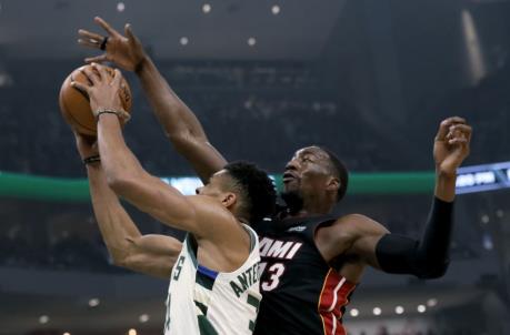 Giannis Antetokounmpo #34 of the Milwaukee Bucks attempts a shot while being guarded by Bam Adebayo #13 of the Miami Heat (Photo by Dylan Buell/Getty Images)