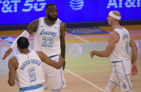 LOS ANGELES, CA - DECEMBER 25: Talen Horton-Tucker #5, LeBron James #23 and Alex Caruso #4 of the Los Angeles Lakers while playing the Dallas Mavericks at Staples Center on December 25, 2020 in Los Angeles, California. (Photo by John McCoy/Getty Images)