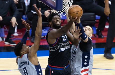 May 23, 2021; Philadelphia, Pennsylvania, USA; Philadelphia 76ers center Joel Embiid (21) drives for a shot between Washington Wizards center Alex Len (27) and forward Rui Hachimura (8) during the second quarter of game one in the first round of the 2021 NBA Playoffs at Wells Fargo Center. Mandatory Credit: Bill Streicher-USA TODAY Sports