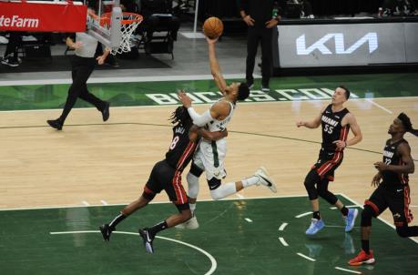 Miami Heat forward Trevor Ariza (8) fouls Milwaukee Bucks forward Giannis Antetokounmpo (34) on his way to the basket
(Michael McLoone-USA TODAY Sports)