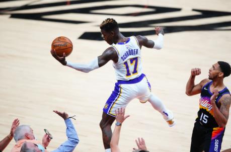 May 23, 2021; Phoenix, Arizona, USA; Los Angeles Lakers guard Dennis Schroder (17) flies out of bounds as he goes for a loose ball against the Phoenix Suns in the second half during game one in the first round of the 2021 NBA Playoffs at Phoenix Suns Arena. Mandatory Credit: Mark J. Rebilas-USA TODAY Sports