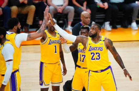 May 25, 2021; Phoenix, Arizona, USA; Los Angeles Lakers forward LeBron James (23) celebrates with teammates against the Phoenix Suns during the first half in game two of the first round of the 2021 NBA Playoffs at Phoenix Suns Arena. Mandatory Credit: Mark J. Rebilas-USA TODAY Sports