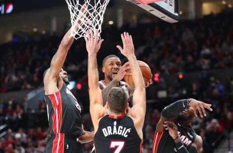 Damian Lillard #0 of the Portland Trail Blazers takes a shot against Andre Iguodala #28 (L), Goran Dragic #7 and Jae Crowder #99 of the Miami Heat (Photo by Abbie Parr/Getty Images)