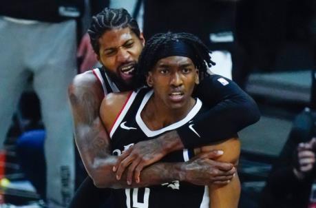 Jun 18, 2021; Los Angeles, California, USA; LA Clippers guard Terance Mann (14) is hugged by teammate Paul George after a first quarter slam dunk against the Utah Jazz during game six in the second round of the 2021 NBA Playoffs. at Staples Center. Mandatory Credit: Robert Hanashiro-USA TODAY Sports