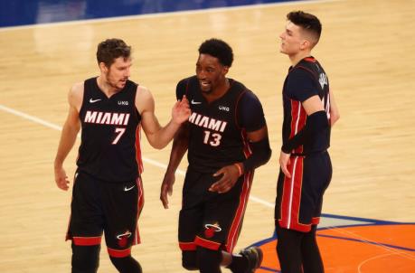 NEW YORK, NEW YORK - MARCH 29: Bam Adebayo #13 of the Miami Heat celebrates his basket with Goran Dragic #7 and Tyler Herro #14 against the New York Knicks at Madison Square Garden on March 29, 2021 in New York City. NOTE TO USER: User expressly acknowledges and agrees that, by downloading and or using this photograph, User is co<em></em>nsenting to the terms and co<em></em>nditions of the Getty Images License Agreement. (Photo by Mike Stobe/Getty Images)