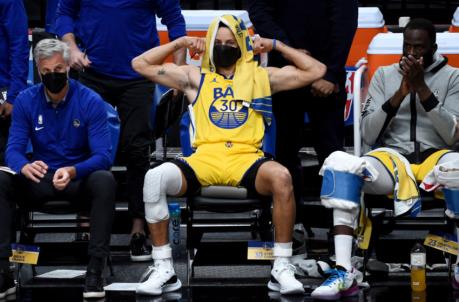 Mar 3, 2021; Portland, Oregon, USA; Golden State Warriors guard Stephen Curry (30) reacts from the bench to a teammates basket during the first half of the game against the Portland Trail Blazers at Moda Center. Mandatory Credit: Steve Dykes-USA TODAY SPORTS