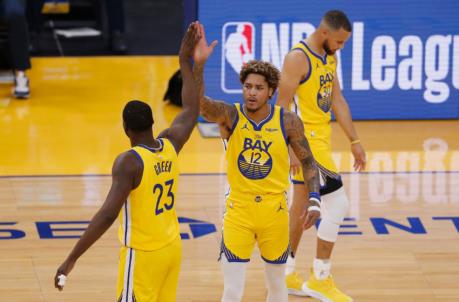 SAN FRANCISCO, CALIFORNIA - APRIL 23: Kelly Oubre Jr. #12 of the Golden State Warriors celebrates with Draymond Green after making a basket in the first quarter against the Denver Nuggets at Chase Center on April 23, 2021 in San Francisco, California. NOTE TO USER: User expressly acknowledges and agrees that, by downloading and or using this photograph, User is co<em></em>nsenting to the terms and co<em></em>nditions of the Getty Images License Agreement. (Photo by Lachlan Cunningham/Getty Images)