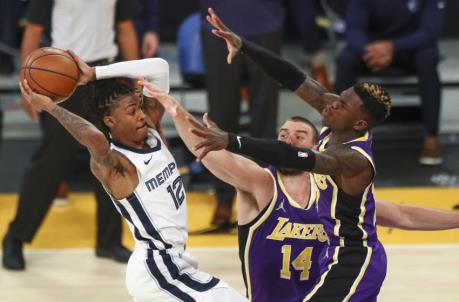 LOS ANGELES, CALIFORNIA - FEBRUARY 12: Ja Morant #12 of the Memphis Grizzlies looks to pass the ball defended by Marc Gasol #14 and Dennis Schroder #17 of the Los Angeles Lakers at Staples Center on February 12, 2021 in Los Angeles, California. NOTE TO USER: User expressly acknowledges and agrees that, by downloading and or using this photograph, User is co<em></em>nsenting to the terms and co<em></em>nditions of the Getty Images License Agreement. (Photo by Meg Oliphant/Getty Images)