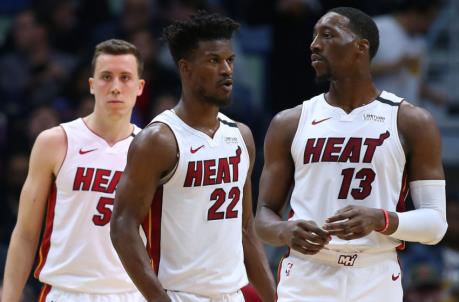 Jimmy Butler #22 of the Miami Heat, Bam Adebayo #13 and Duncan Robinson #55 react against the New Orleans Pelicans. (Photo by Jo<em></em>nathan Bachman/Getty Images)