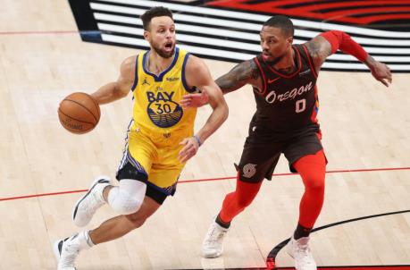 PORTLAND, OREGON - MARCH 03: Stephen Curry #30 of the Golden State Warriors dribbles against Damian Lillard #0 of the Portland Trail Blazers in the first quarter at Moda Center on March 03, 2021 in Portland, Oregon. NOTE TO USER: User expressly acknowledges and agrees that, by downloading and or using this photograph, User is co<em></em>nsenting to the terms and co<em></em>nditions of the Getty Images License Agreement. (Photo by Abbie Parr/Getty Images)