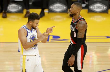 SAN FRANCISCO, CALIFORNIA - JANUARY 01: Stephen Curry #30 of the Golden State Warriors reacts in front of Damian Lillard #0 of the Portland Trail Blazers at Chase Center on January 01, 2021 in San Francisco, California. NOTE TO USER: User expressly acknowledges and agrees that, by downloading and or using this photograph, User is co<em></em>nsenting to the terms and co<em></em>nditions of the Getty Images License Agreement. (Photo by Ezra Shaw/undefined)