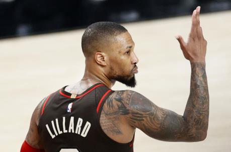 PORTLAND, OREGON - JUNE 03: Damian Lillard #0 of the Portland Trail Blazers reacts after his three point basket in the second quarter against the Denver Nuggets during Round 1, Game 6 of the 2021 NBA Playoffs at Moda Center on June 03, 2021 in Portland, Oregon. NOTE TO USER: User expressly acknowledges and agrees that, by downloading and or using this photograph, User is co<em></em>nsenting to the terms and co<em></em>nditions of the Getty Images License Agreement. (Photo by Steph Chambers/Getty Images)