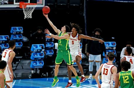 Mar 28, 2021; Indianapolis, Indiana, USA; Oregon Ducks guard Chris Duarte (5) shoots the ball against USC Trojans guard Isaiah White (5) during the first half in the Sweet Sixteen of the 2021 NCAA Tournament at Bankers Life Fieldhouse. Mandatory Credit: Trevor Ruszkowski-USA TODAY Sports