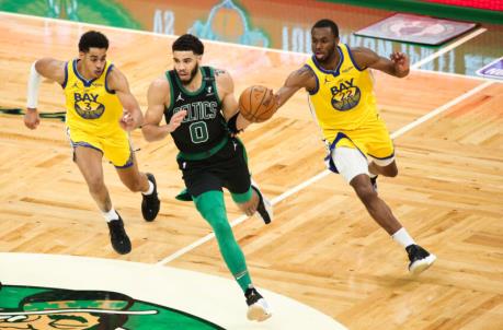 BOSTON, MA - APRIL 17: Jayson Tatum #0 of the Boston Celtics dribbles past Jordan Poole #3 and and Andrew Wiggins #22 of the Golden State Warriors in the second half at TD Garden on April 17, 2021 in Boston, Massachusetts. NOTE TO USER: User expressly acknowledges and agrees that, by downloading and or using this photograph, User is co<em></em>nsenting to the terms and co<em></em>nditions of the Getty Images License Agreement. (Photo by Kathryn Riley/Getty Images)