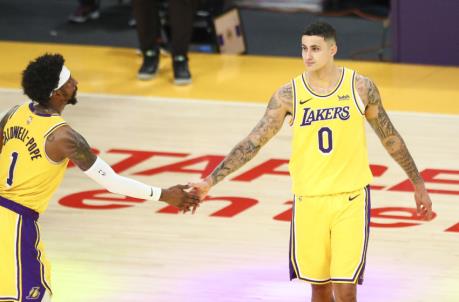 LOS ANGELES, CALIFORNIA - FEBRUARY 20: Kyle Kuzma #0 of the Los Angeles Lakers high-fives Kentavious Caldwell-Pope #1 after the game against the Miami Heat at Staples Center on February 20, 2021 in Los Angeles, California. NOTE TO USER: User expressly acknowledges and agrees that, by downloading and or using this photograph, User is co<em></em>nsenting to the terms and co<em></em>nditions of the Getty Images License Agreement. (Photo by Meg Oliphant/Getty Images)