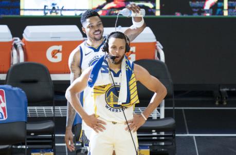 May 16, 2021; San Francisco, California, USA; Golden State Warriors guard Stephen Curry (30) is interviewed as forward Kent Bazemore (26) pours water after the game against the Memphis Grizzlies at Chase Center. Mandatory Credit: Kyle Terada-USA TODAY Sports