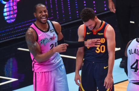 MIAMI, FL - APRIL 01: Andre Iguodala #28 of the Miami Heat and Stephen Curry #30 of the Golden State Warriors share a laugh at the end of the game at the American Airlines Arena on April 1, 2021 in Miami, Florida. NOTE TO USER: User expressly acknowledges and agrees that, by downloading and or using this photograph, User is co<em></em>nsenting to the terms and co<em></em>nditions of the Getty Images License Agreement.(Photo by Eric Espada/Getty Images)