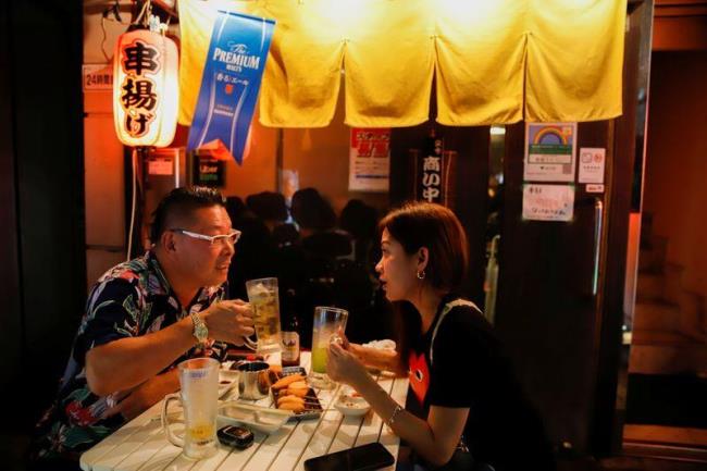 A couple is seen sitting at an outdoor table of a restaurant in Ikebukuro area amid the coro<em></em>navirus disease (COVID-19) outbreak in Tokyo