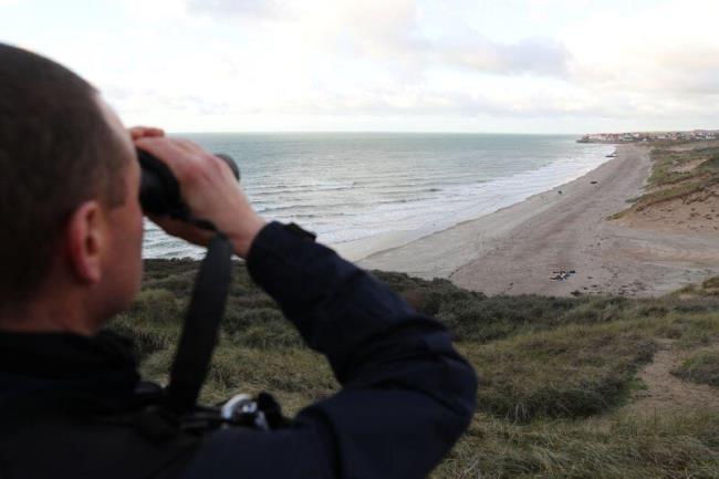 French police patrol the beach in Wimereux after migrant tragedy