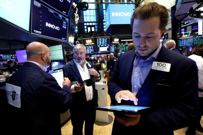 Traders work on the floor of the NYSE in New York