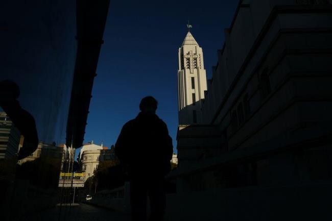 A person walks by a church in the center of Lisbon