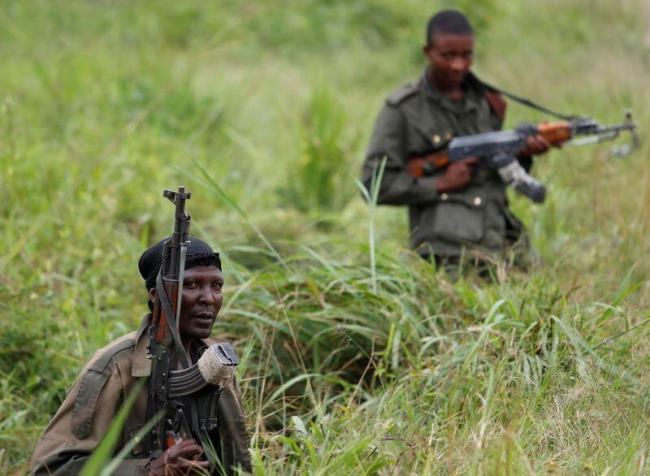 Armed Forces of the Democratic Republic of the Co<em></em>ngo (FARDC) soldiers rest next to a road after Islamist rebel group called the Allied Democratic Forces (ADF) attacked area around Mukoko village