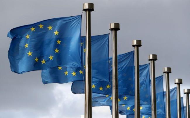 EU flags flutter in front of the European Commission headquarters in Brussels