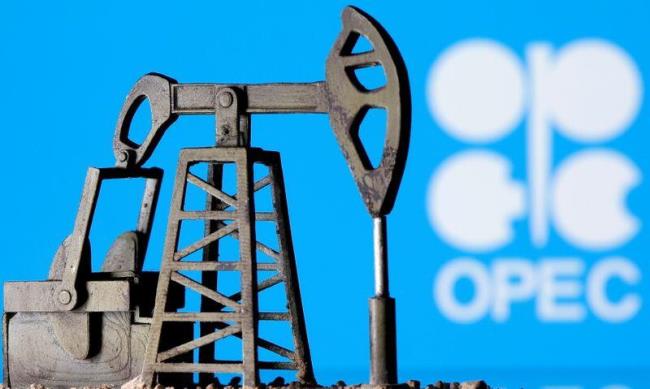 A 3D printed oil pump jack is seen in front of displayed OPEC logo in this illustration picture