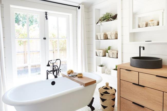 Bright decorated kitchen with bamboo Roman shades covering window over sink