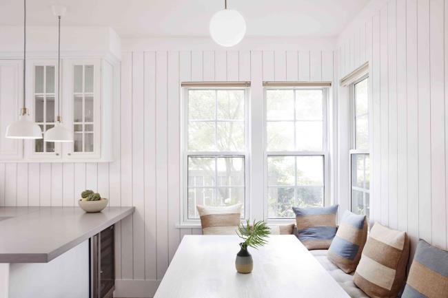 Dining corner near bright windows with Venetian blinds