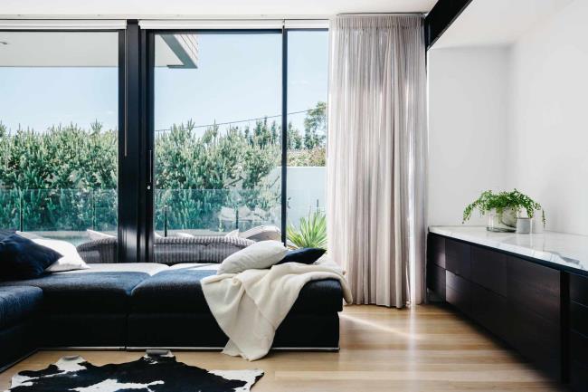 Modern black and white living room with floor to ceiling curtains