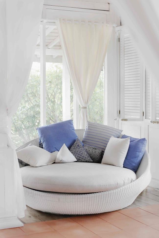 Large papasan chair with nautical colored pillows