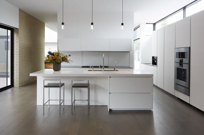 White and sleek large modern kitchen