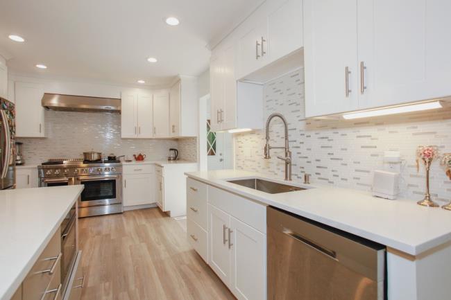 white kitchen with stainless steel appliances