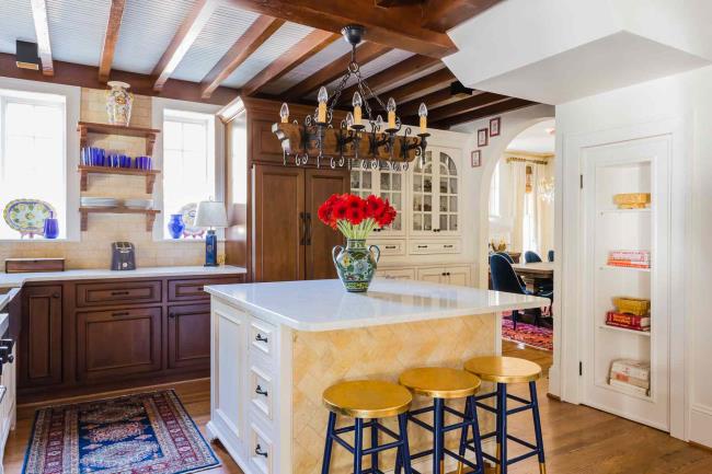 spanish kitchen with white quartz counters and limestone backsplash