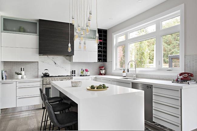 White quartz waterfall countertop in a modern kitchen