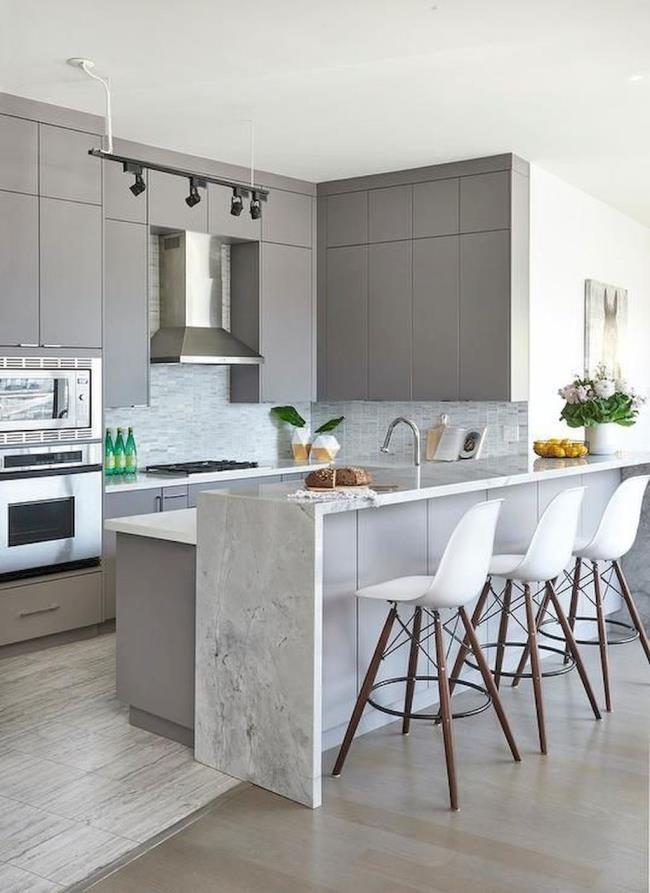 White granite waterfall countertop with white plastic and wood barstool chairs