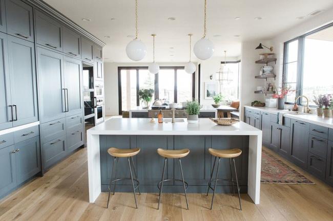 blue kitchen with waterfall countertop