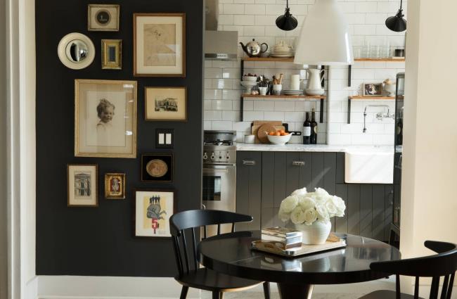 Stained black wood shiplap cabinets and woven pendant lamps in a kitchen